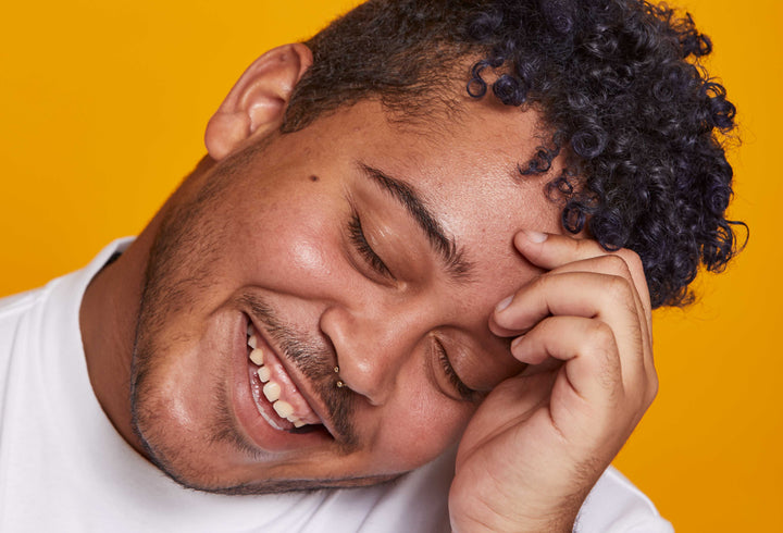 Latino man with short, curly hair